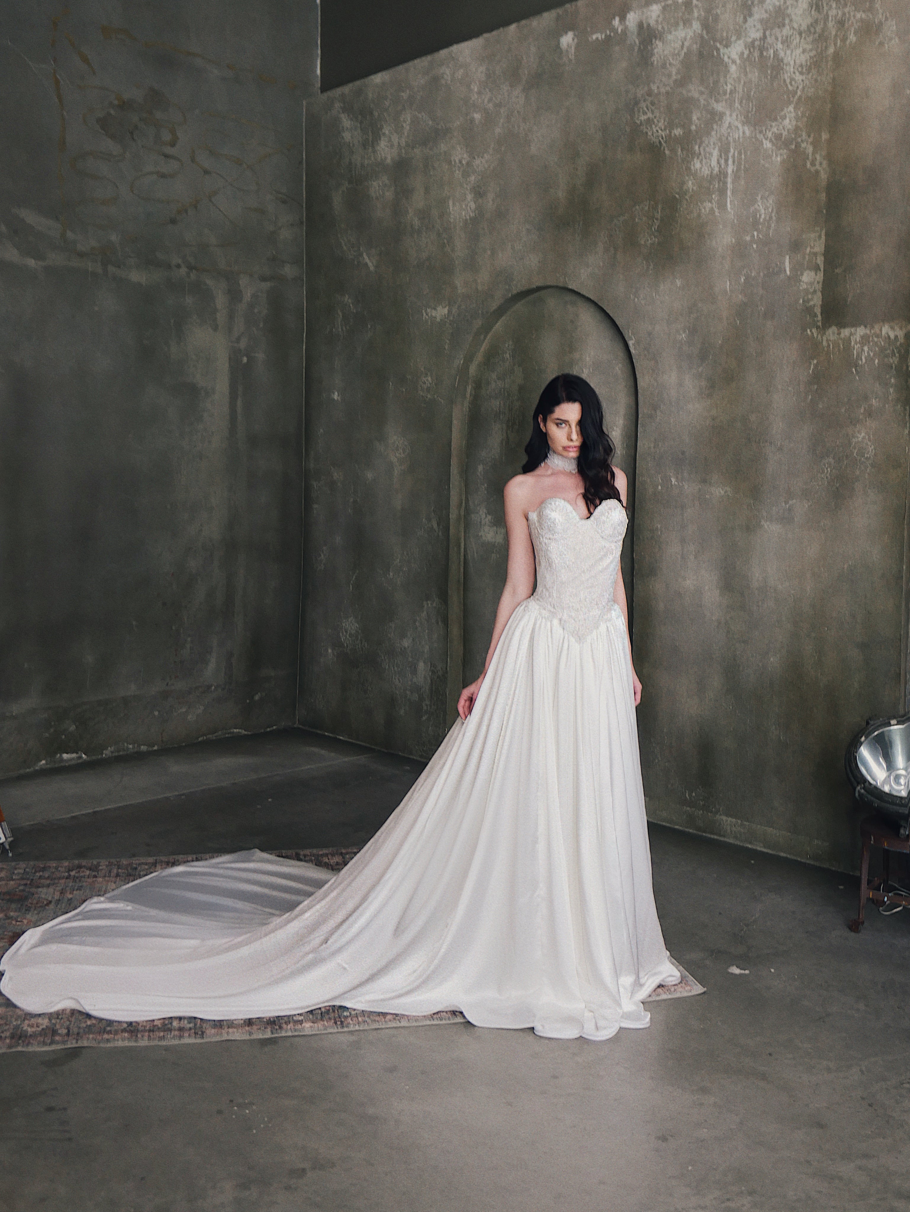 A model wears the Lauren Elaine "Regency" basque waist  lace bridal corset w/ "Solitaire" skirt.