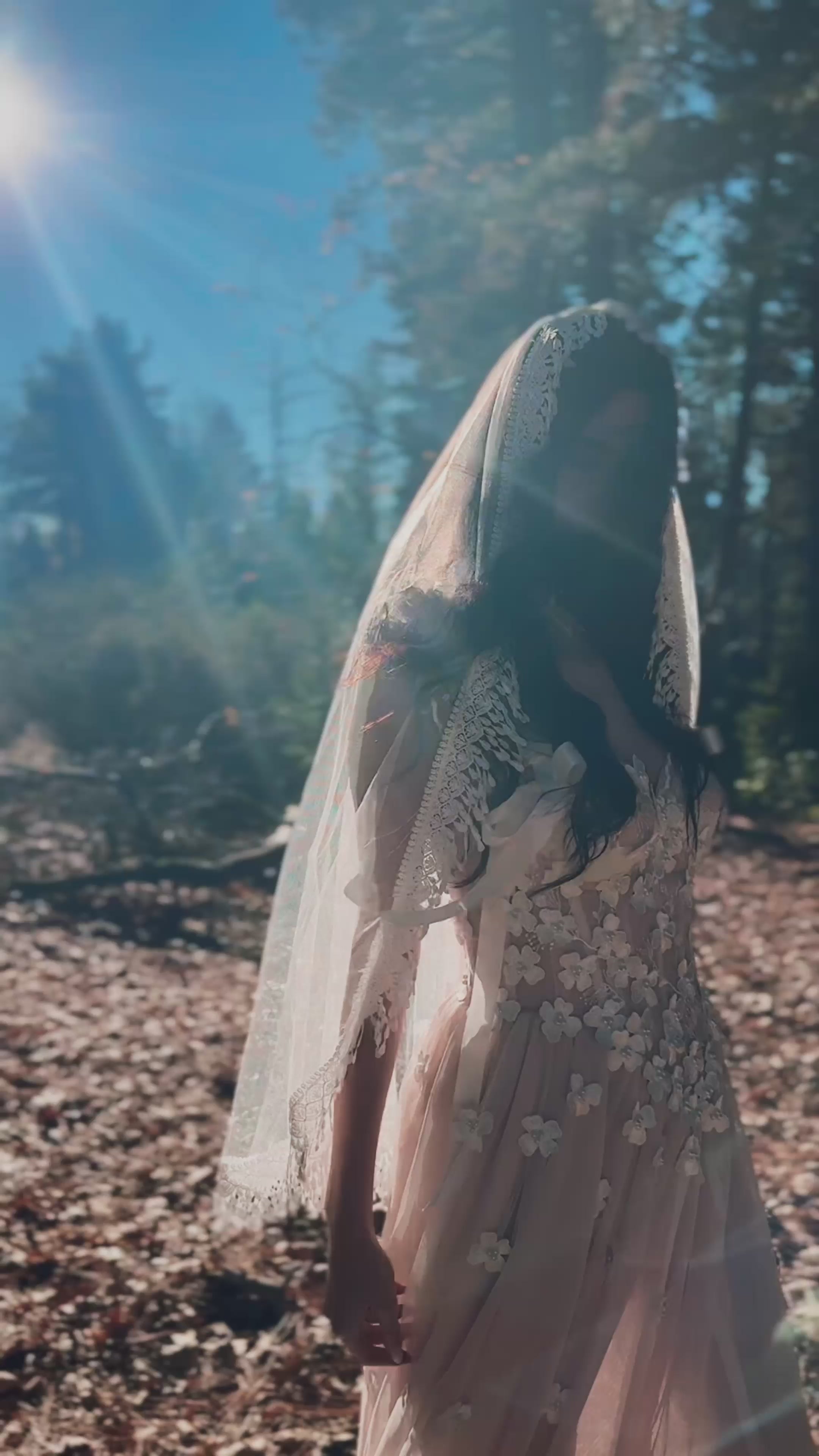 Bohemian crochet wedding veil with soft fringe trim, styled for an ethereal forest wedding aesthetic.