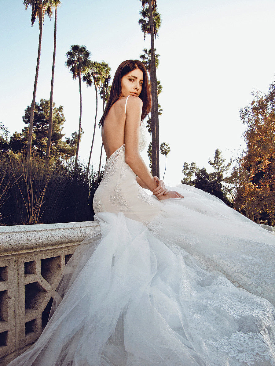 Dramatic and sexy backless mermaid wedding gown with cathedral tulle and scalloped lace train pictured in park