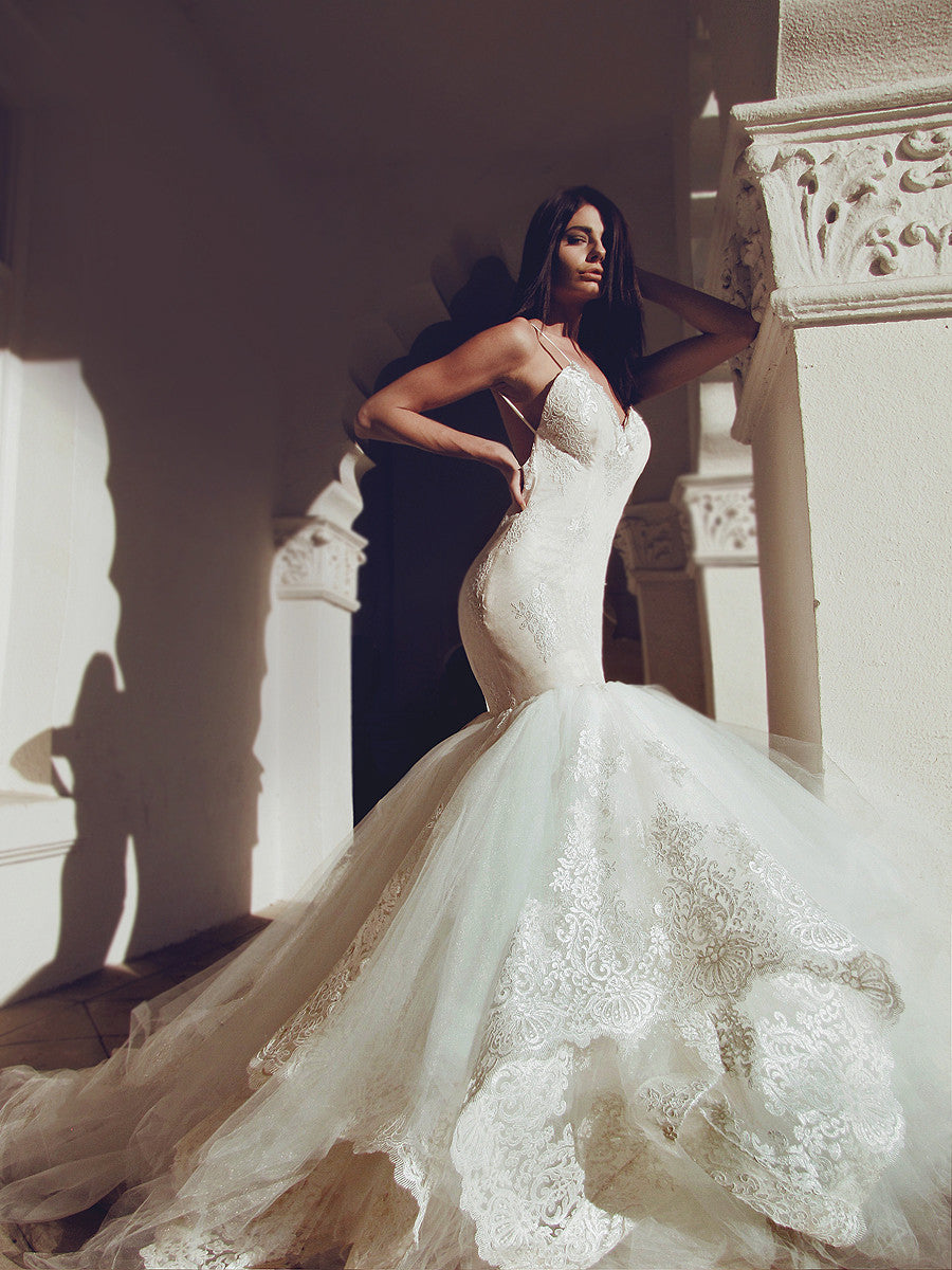 Glamorous designer mermaid wedding dress with tulle and lace cathedral train and horsehair hemline