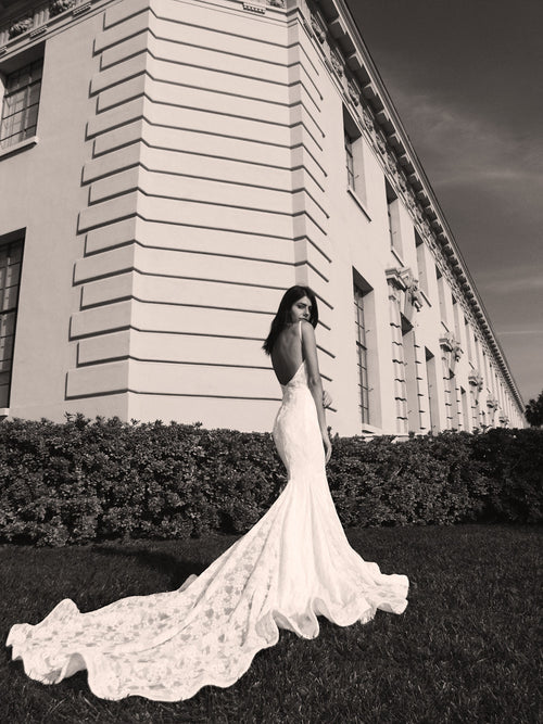 Backless lace mermaid wedding gown with cathedral train and kick pleat details by Lauren Elaine