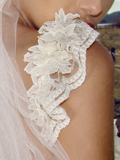 Ruffled lace cap sleeves with corded french lace flowers and pearl beads. Lauren Elaine Camellia Bridal Gown.