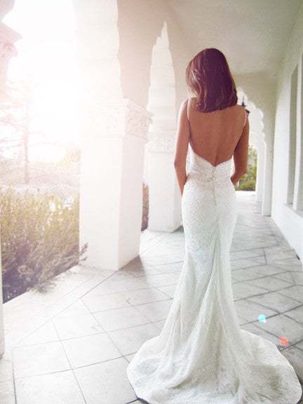 Backless lace wedding gown with train and satin-covered buttons. Isla by Lauren Elaine Bridal.