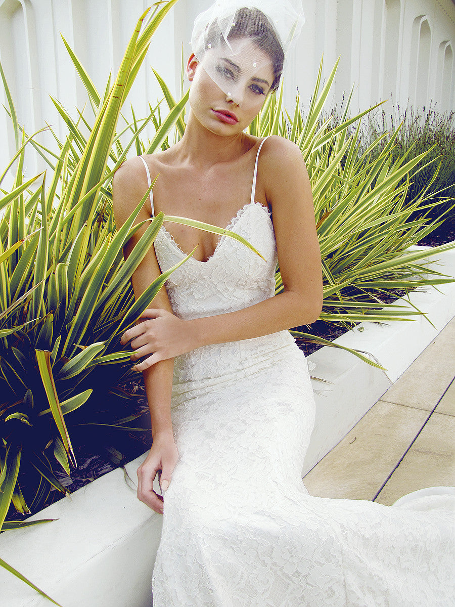 Designer lace wedding gown with plunging sweetheart bodice. 