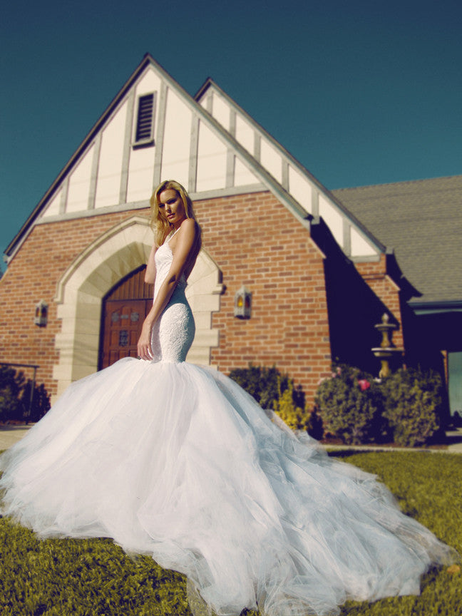 Mermaid wedding gown with detachable cathedral train and dramatic open back silhouette.