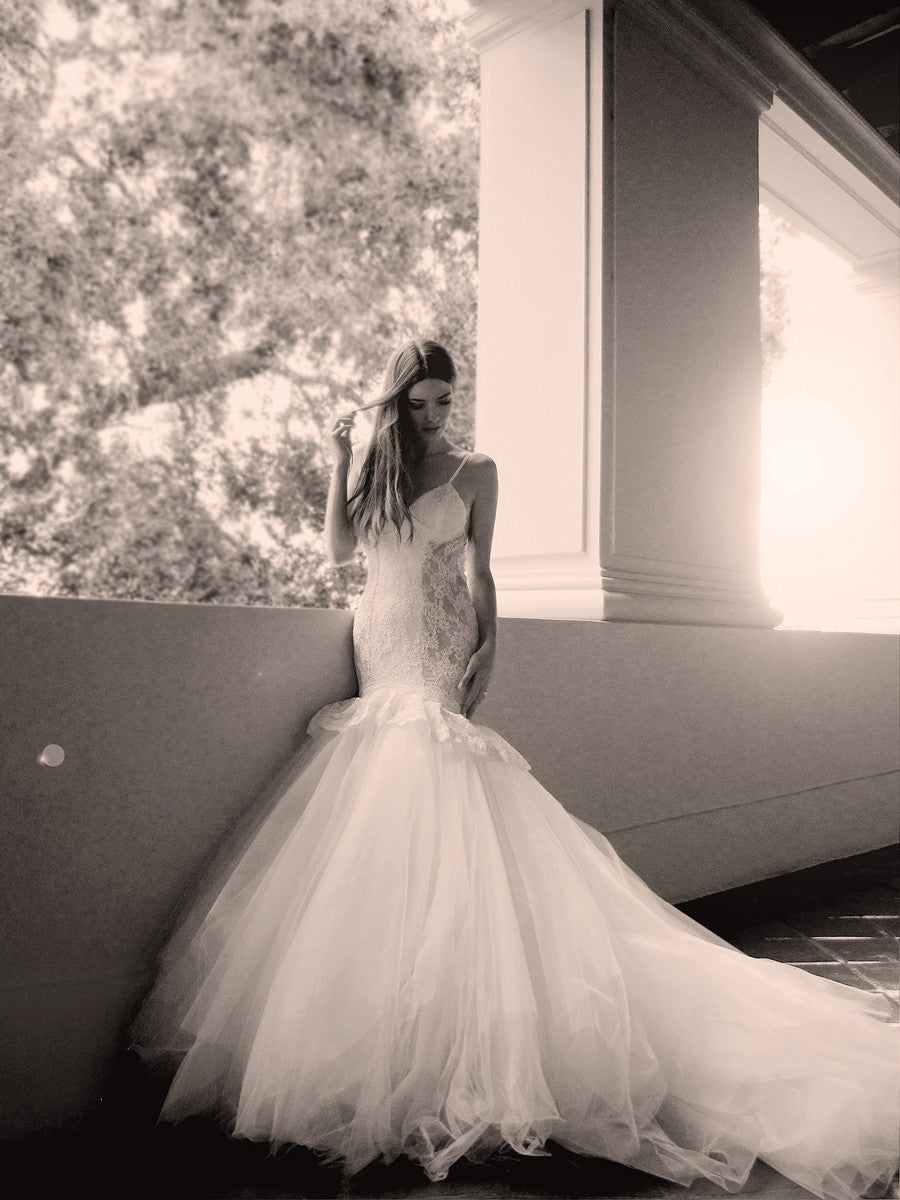 Lace mermaid wedding gown with peplum detailing and tulle skirt with cathedral train
