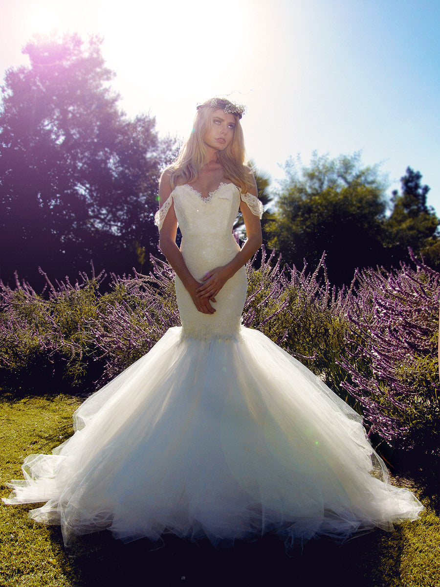Off the shoulder mermaid lace wedding gown with tulle cathedral train.