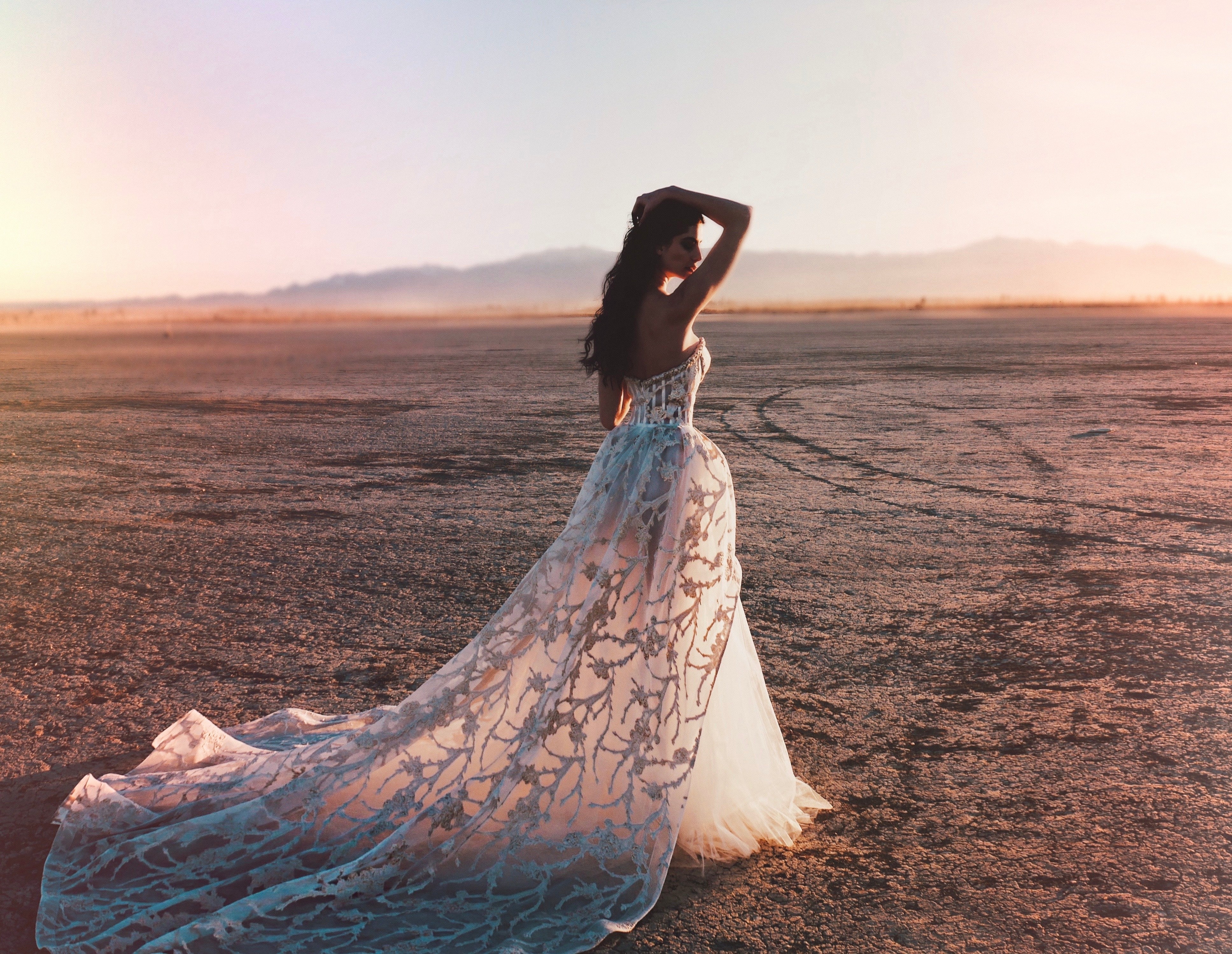 Wide shot of bustier corset ball gown wedding dress shot in desert