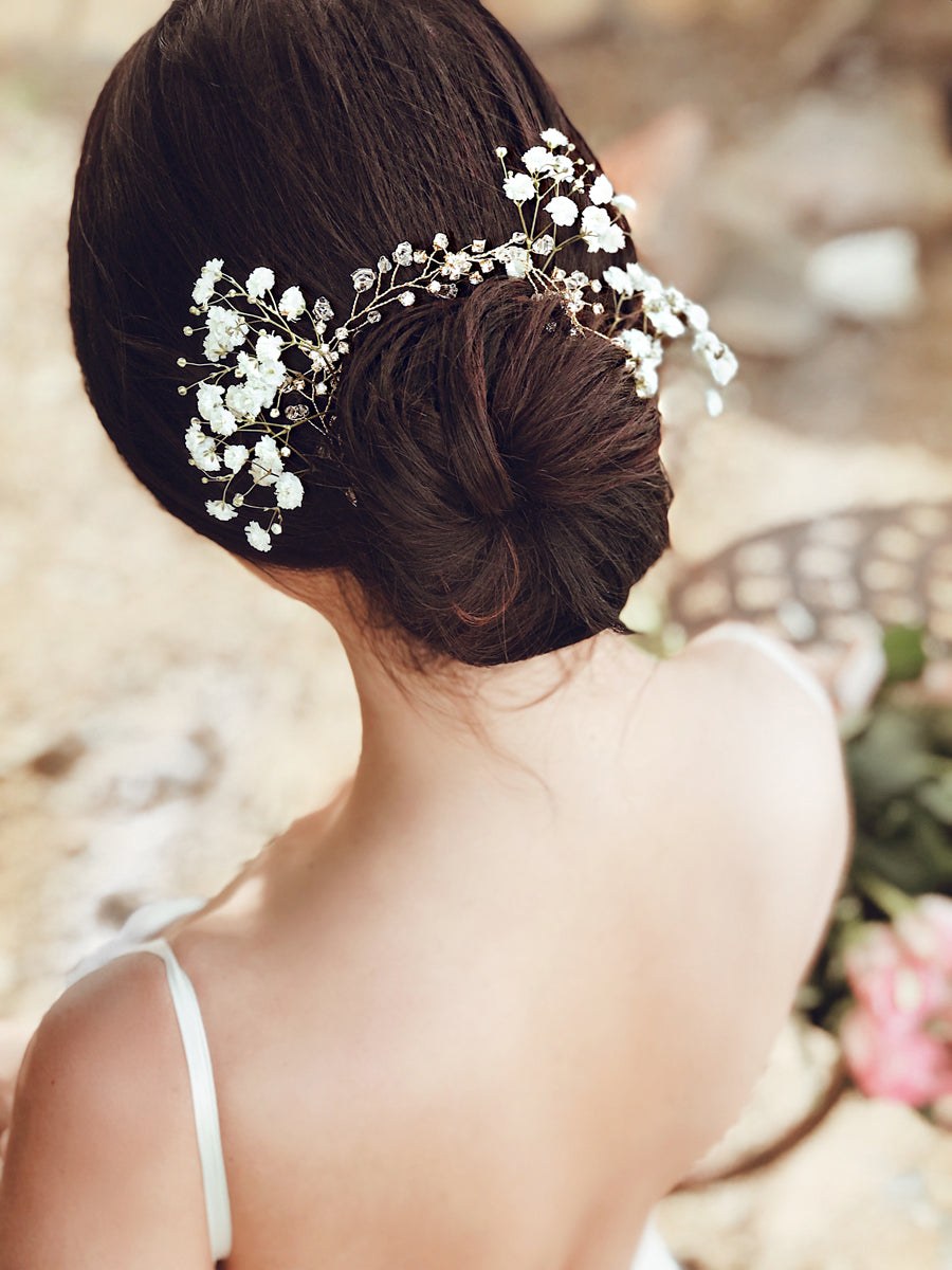 A bride wears the "Laurel" flower crown and hair vine from Lauren Elaine Bridal Accessories paired with baby's breath flowers