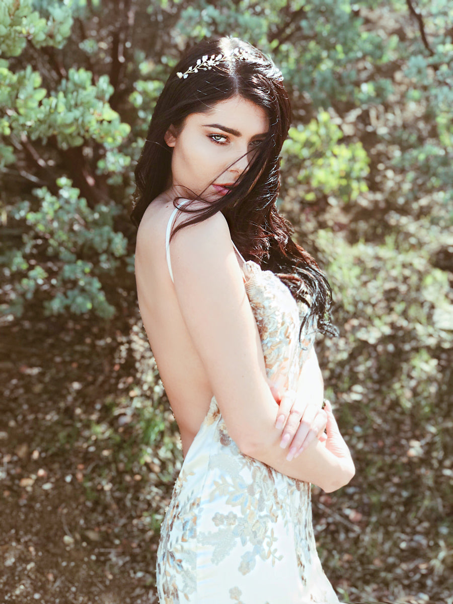 A model wears the "Laurel" hair vine and wedding tiara from Lauren Elaine Bridal in Gold color option