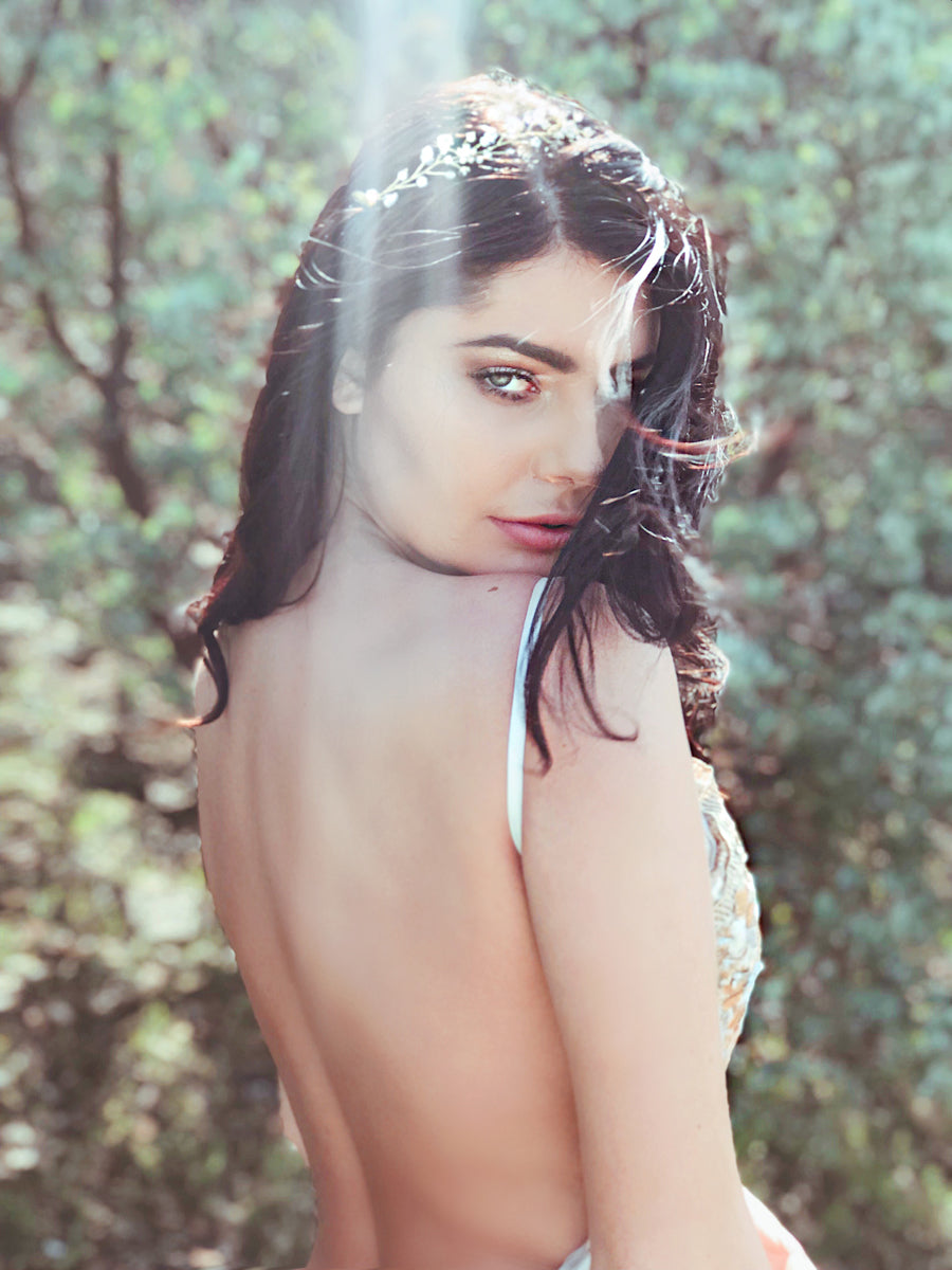 A model wears the "Laurel" swarovski crystal and gold vine wedding tiara from Lauren Elaine Bridal Accessories