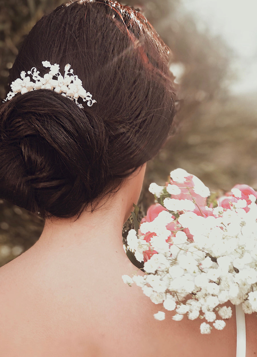 A bride wears the "Lilac" cystal flower and pearl hair comb for wedding look