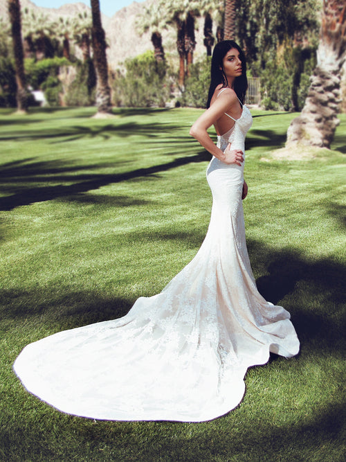Lauren Elaine "Lumen" trumpet wedding dress with cathedral train and sparkle backless silhouette