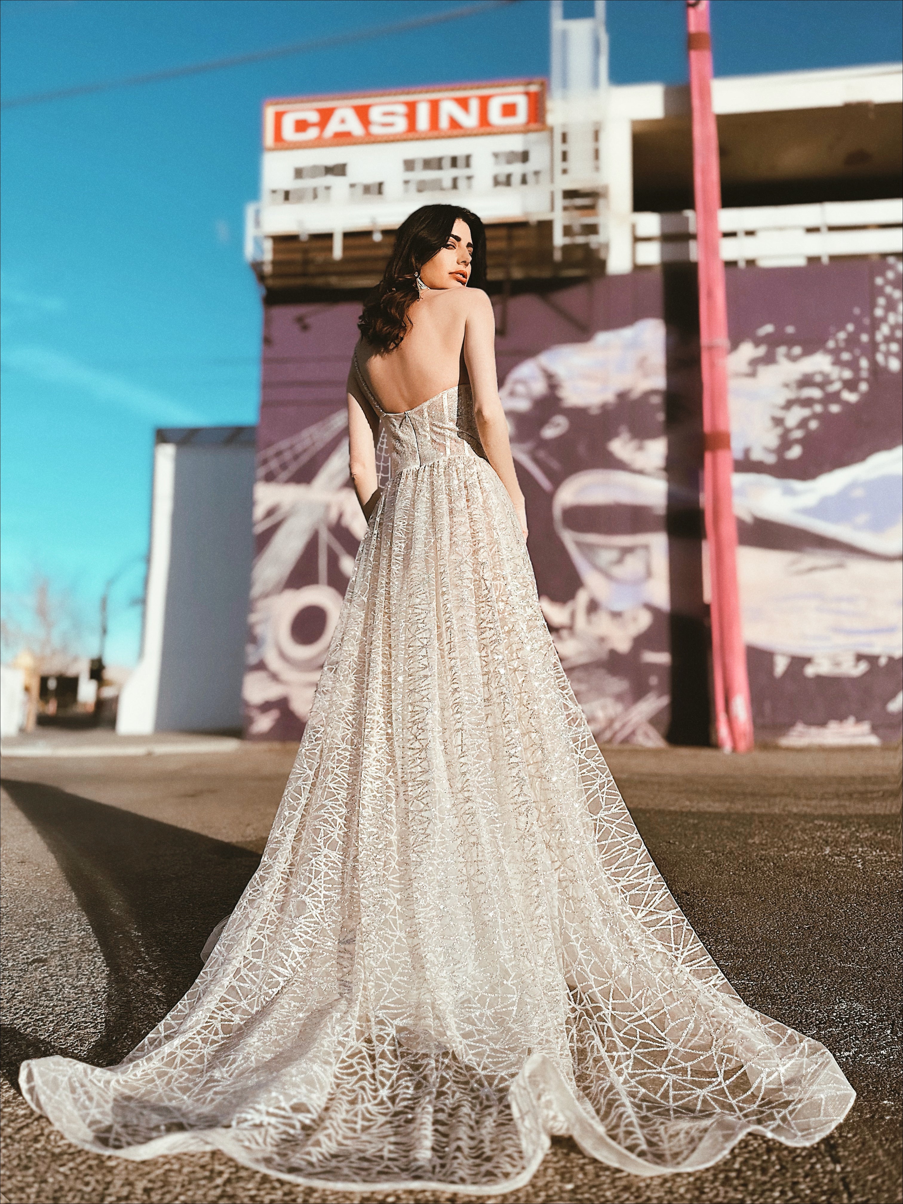 one shoulder corset sparkle A-line wedding dress by Lauren elaine bridal with train