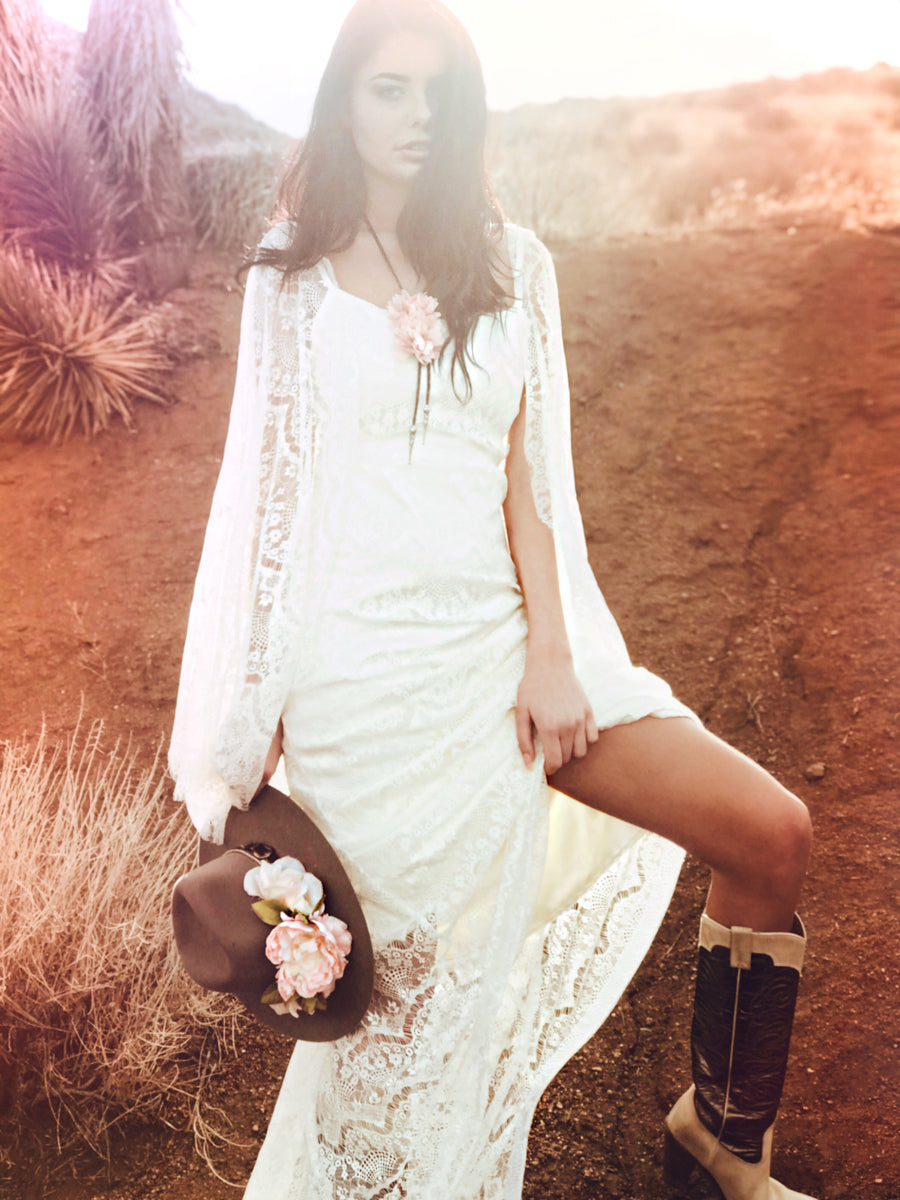 Romantic western cowgirl inspired lace wedding dress with sheath silhouette and chapel train.