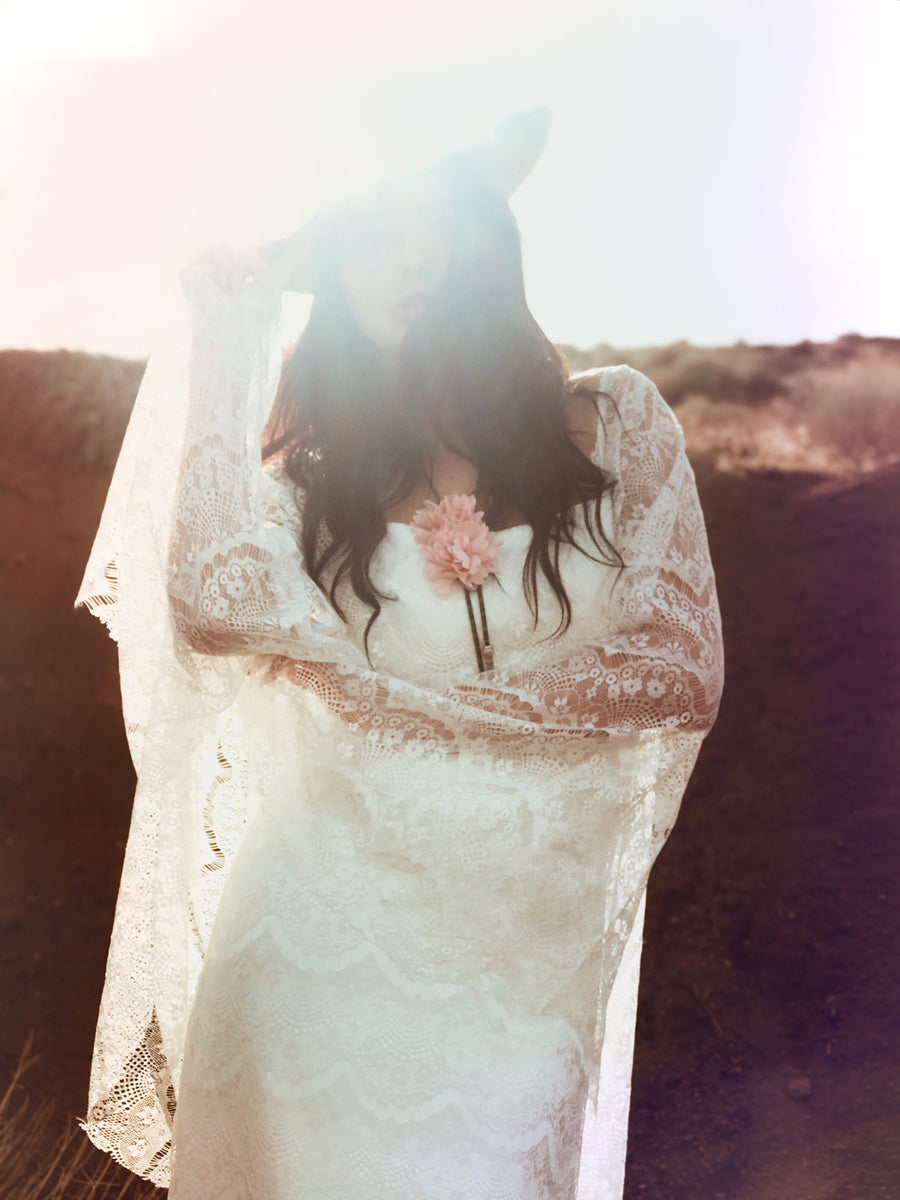 Cowgirl and western inspired bohemian wedding dress with angel wing cape sleeves.