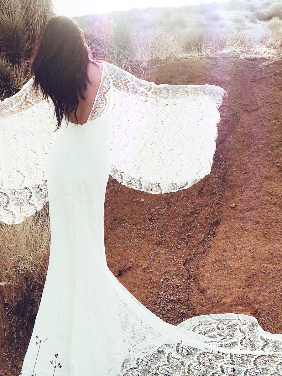 Bohemian lace cape wedding dress with sleeves and eyelash trim detailing. Larkin from the Pearl by Lauren Elaine Collection.