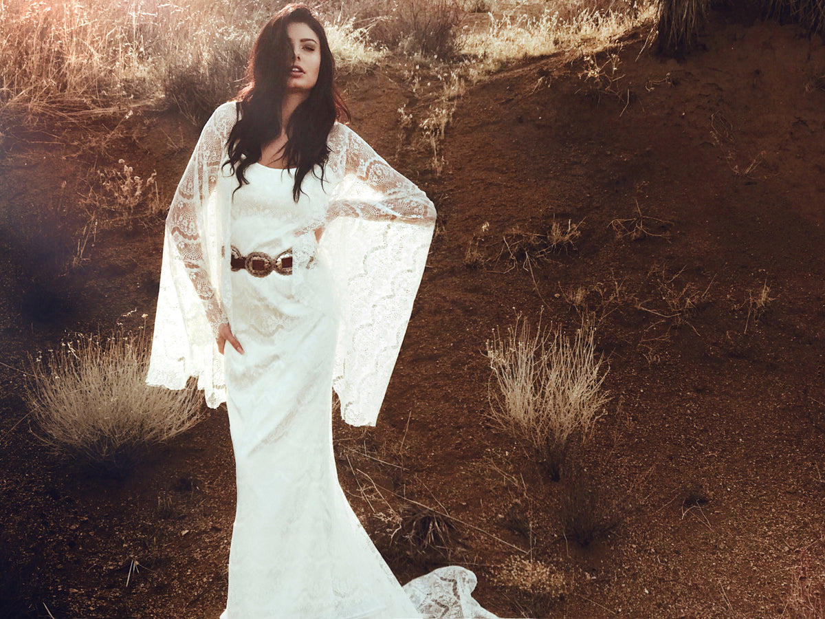 Bohemian western and festival inspired wedding dress with eyelash lace and cape sleeves. Larkin by Lauren Elaine Bridal.