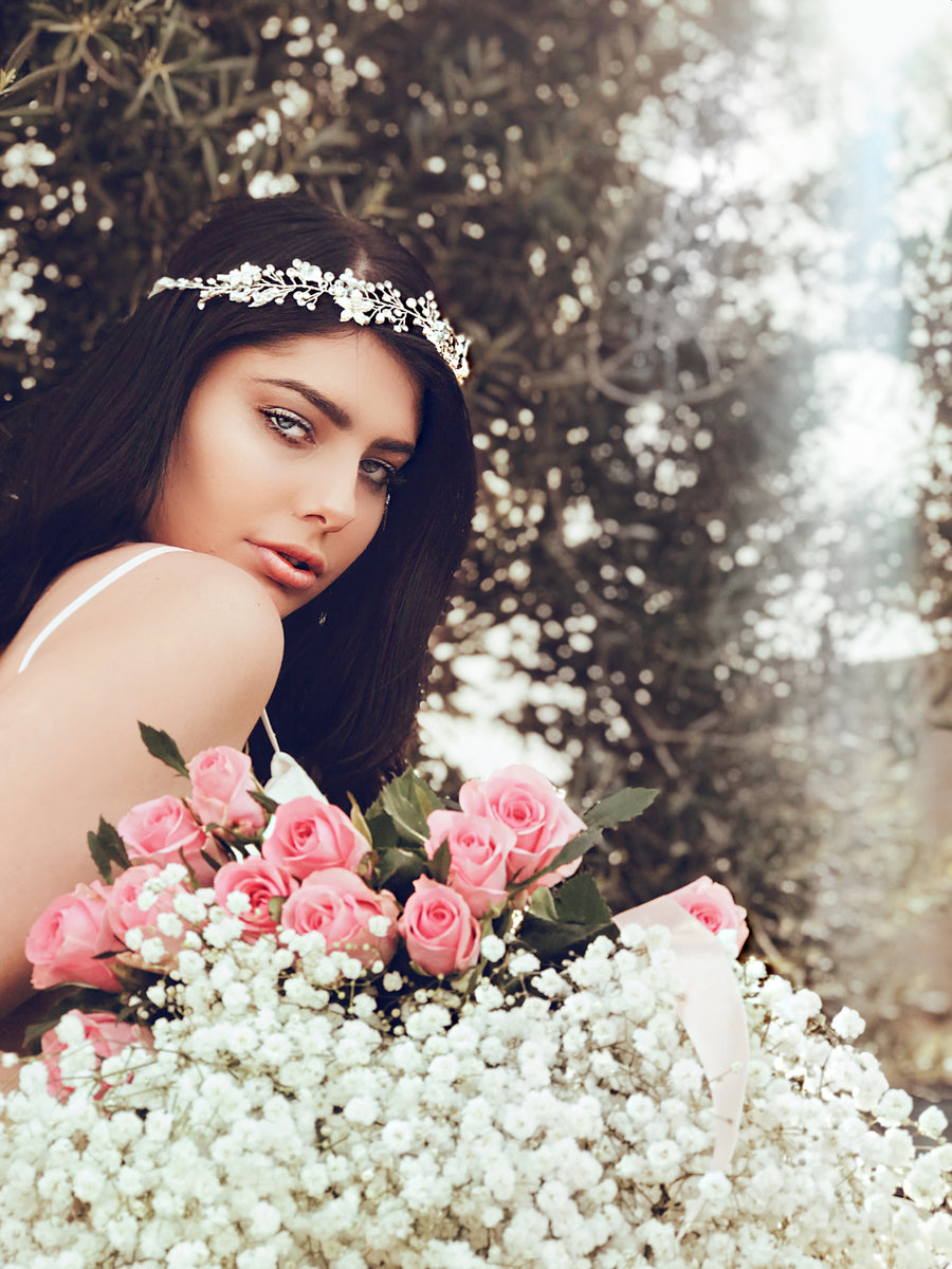 A model wears the "Verbena" pearl and silver hair vine and wedding flower crown with crystal detailing