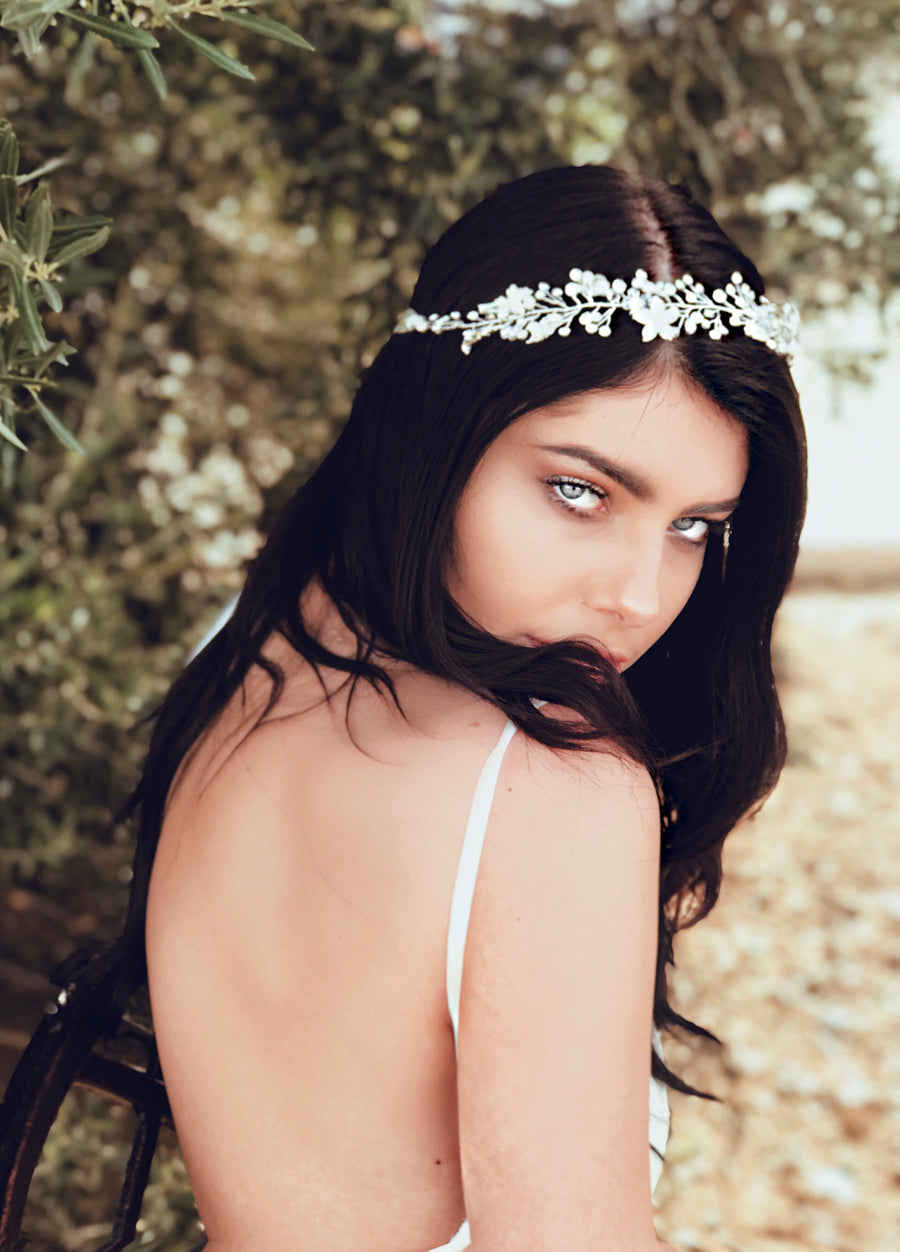 A model wears the crystal and pearl "Verbena" hair vine and wedding flower crown from Lauren Elaine Bridal