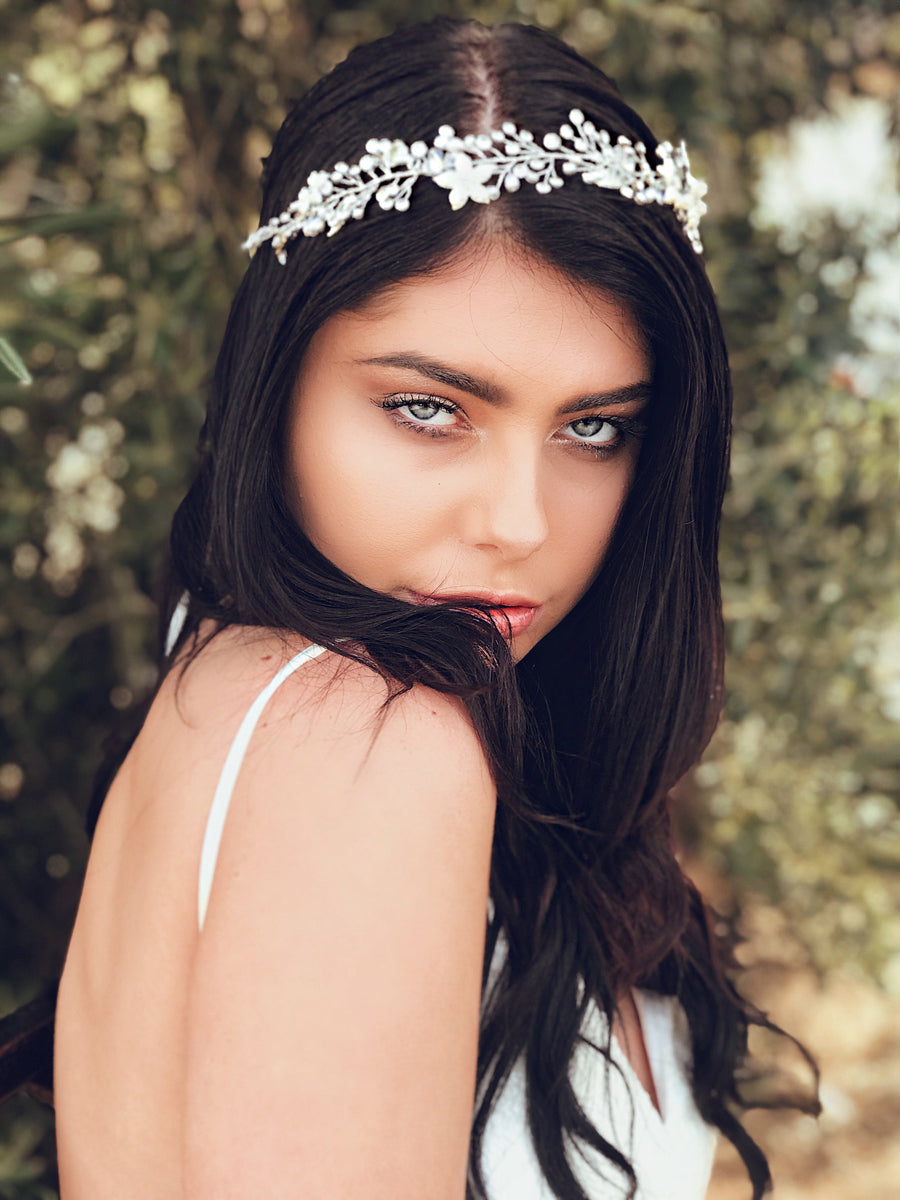 A model wears the "Verbena" silver crystal and pearl flower crown from Lauren Elaine Bridal